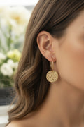 Hoop earrings with hammered circular pendant